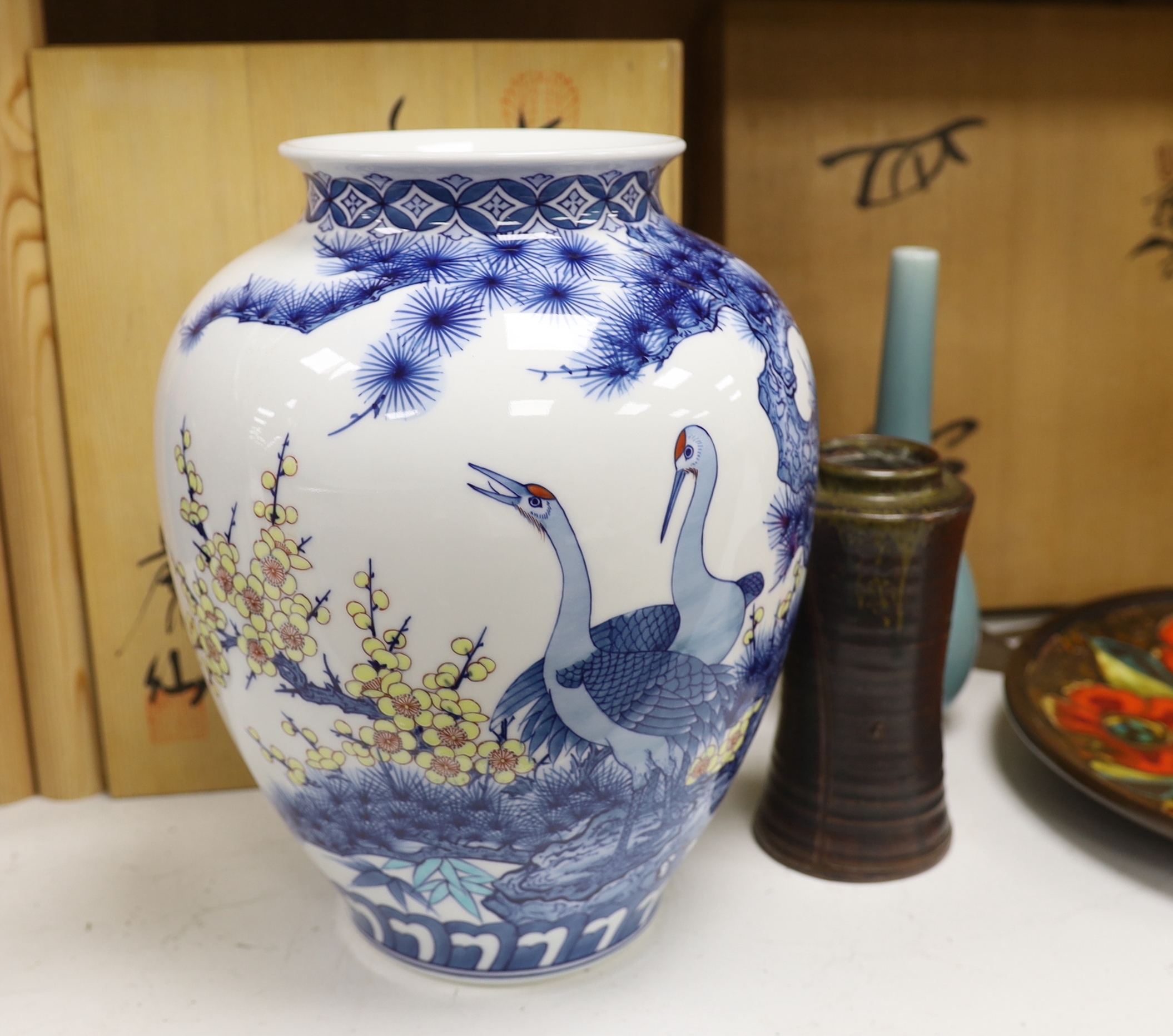 A Japanese blue and white ‘crane’ vase with wooden box, two other Japanese vases and an enamelled dish, also with wooden box. Dish 35cm diameter